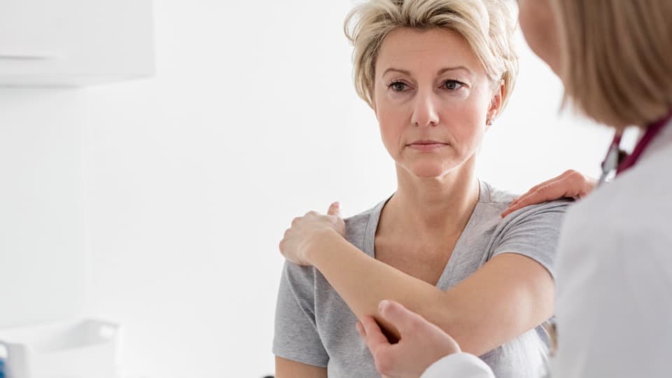 A Polish doctor examines a patient's arm