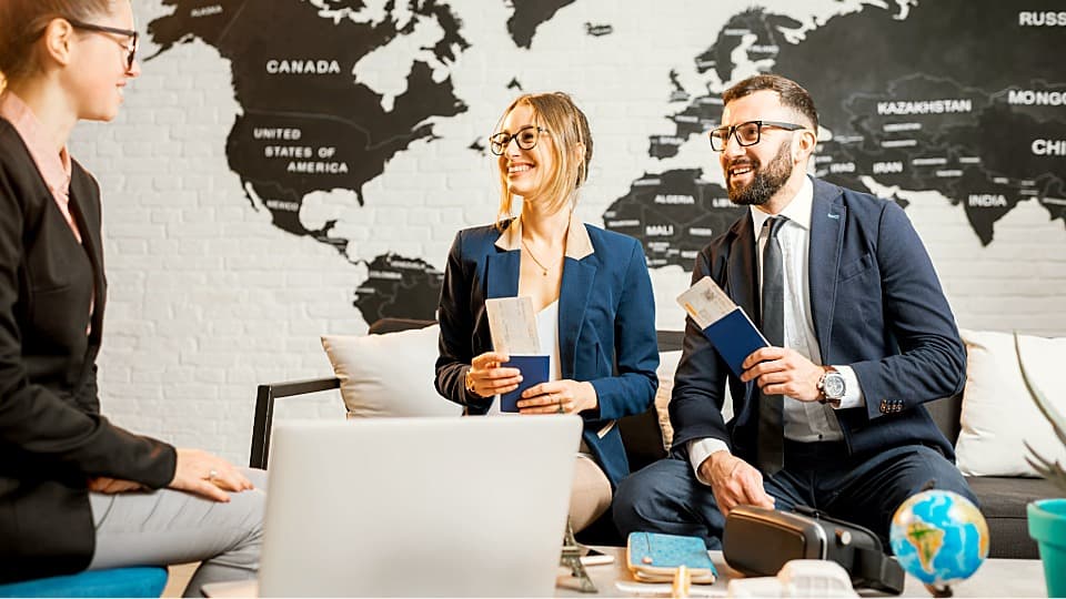 Consultation on the phases of an employee assignment with a business couple holding passports and tickets.