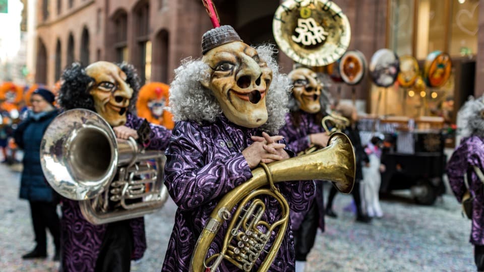 Culture and Traditions in Switzerland - “Tschäggättä” Parade featuring people in costume wearing wooden masks