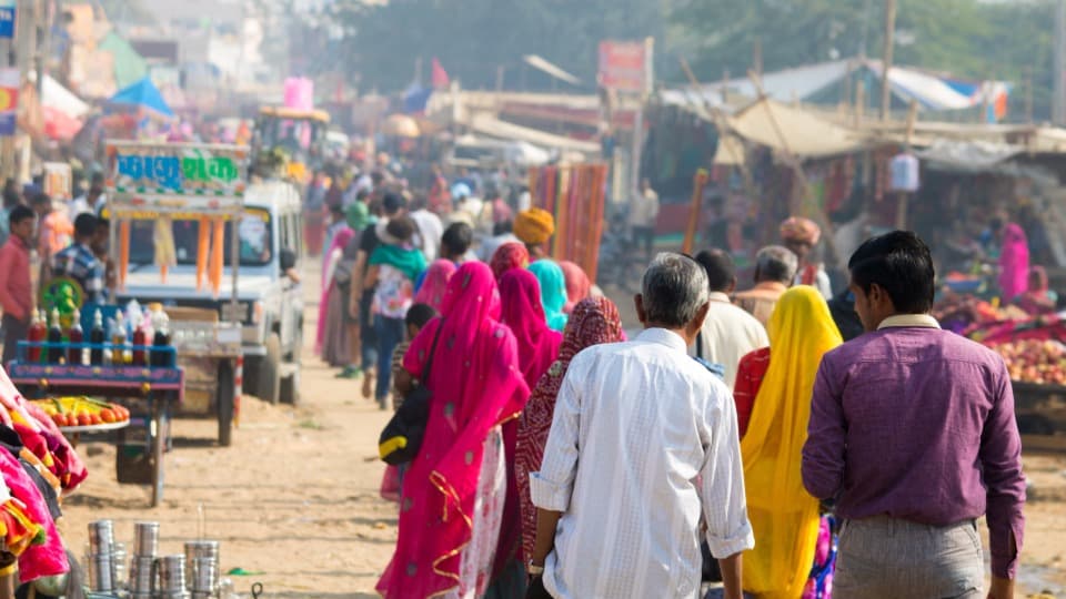 A bustling street in India lined with market stalls