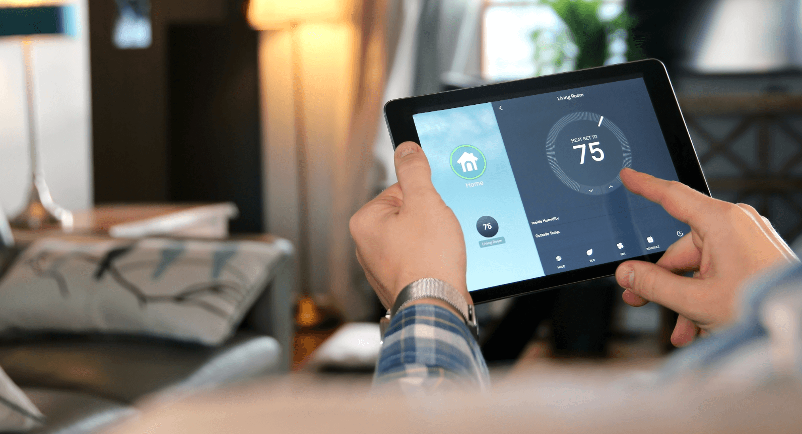 Smart home technology: person adjusts room temperature via tablet for accessible and comfortable living