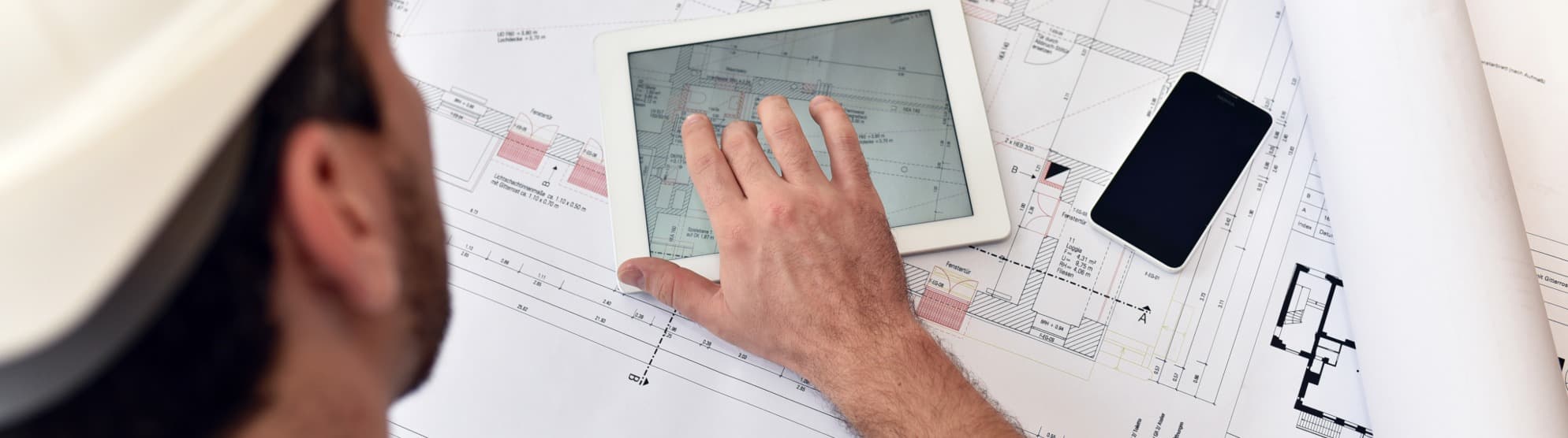 Project manager analyzing the floor plan on a tablet for a seamless site relocation.
