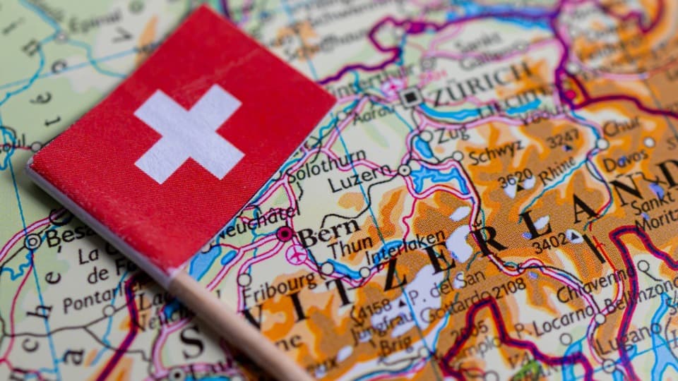 Swiss flag on a map of Switzerland showing cities such as Zurich and Bern