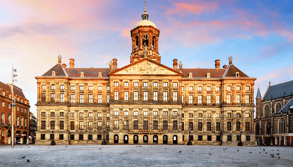 Historic building on Dam Square in Amsterdam in warm evening light