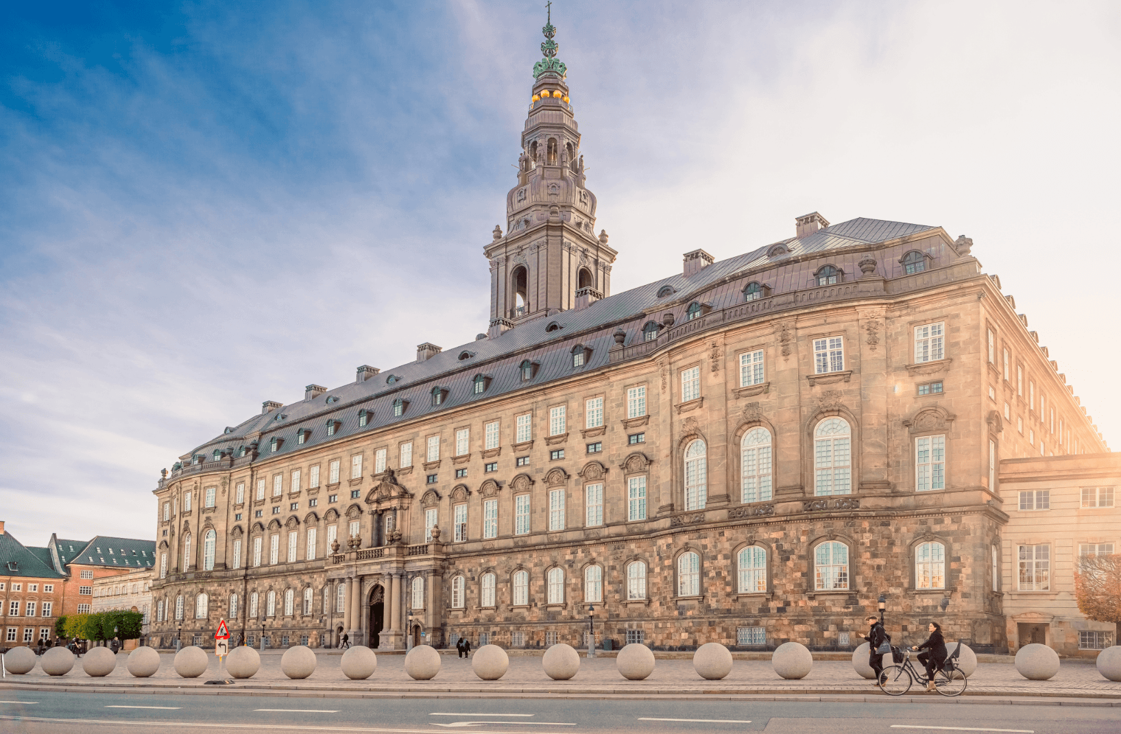 Christiansborg Palace in Copenhagen with cyclists in the foreground