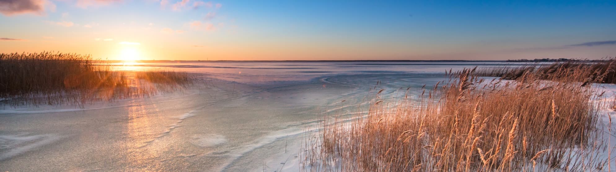 Winter coastal landscape in Denmark at sunset