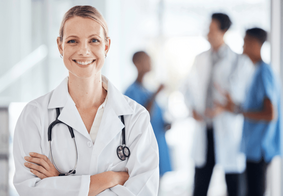 Doctor in a clinic with medical staff in the background as a symbol of healthcare in Finland