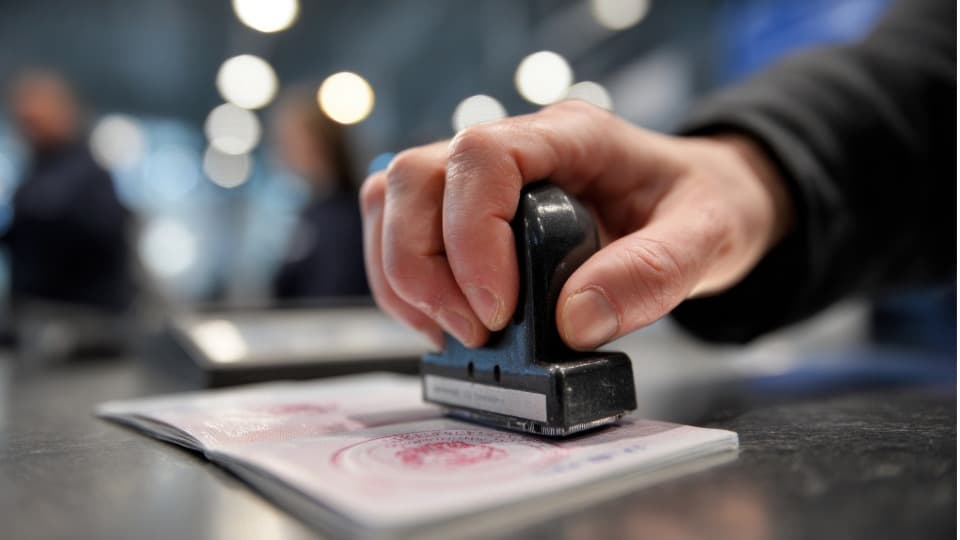 Border officer stamping a passport during entry control