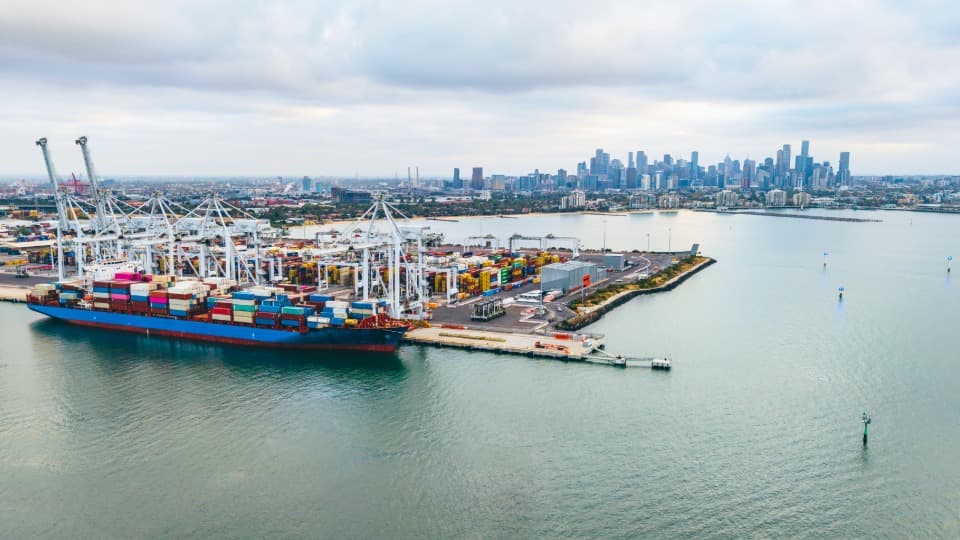 Large container ship at the Port of Melbourne for international overseas relocation and inland transport to Australia with DACHSER & KOLB.