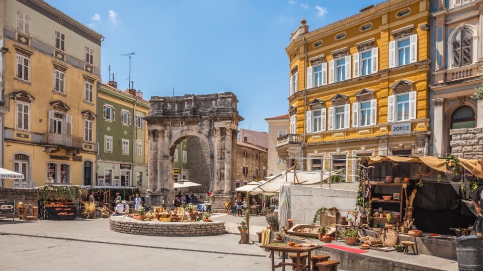 The historic Arch of the Sergii in Pula, symbolizing the Mediterranean lifestyle and culture on Croatia's coast.