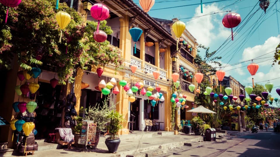 A street in Vietnam, festively decorated with garlands of colorful lanterns