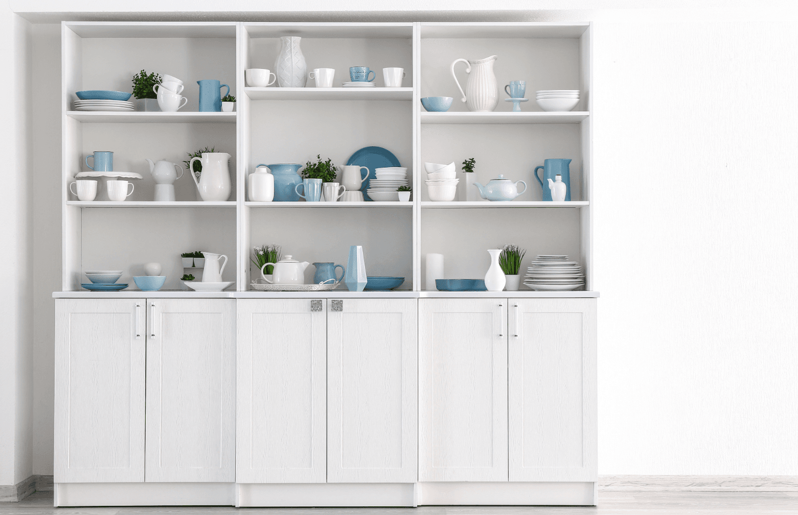 Cabinet assembly: white kitchen cupboard with open shelves, neatly arranged dishes and decor in blue and white