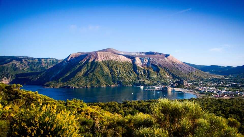 The volcano on Vulcano Island – highlighting volcanic activity and natural risks for expats in Italy.