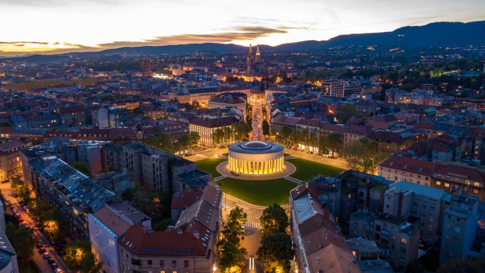 Illuminated Meštrović Pavilion in Zagreb at night, symbolizing the high safety and quality of life in Croatia.
