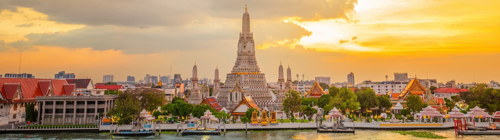 Wat Arun temple in Bangkok on the river at sunset in Thailand