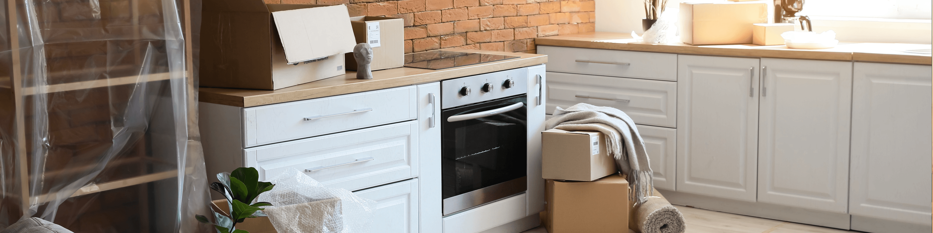 Moving boxes in a new or newly installed kitchen, ready for unpacking. Focus on kitchen installation.