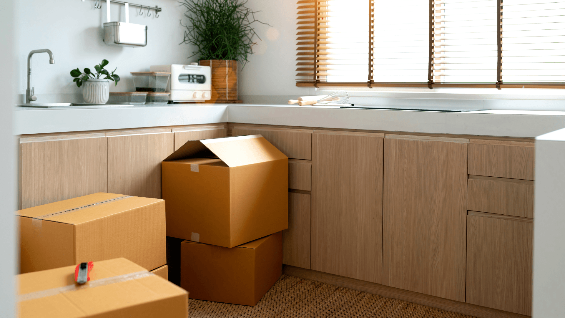 Moving boxes are in a modern kitchen, ready for kitchen installation. New beginning in a new home.
