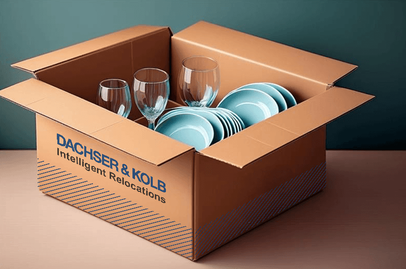 Moving box with plates and glasses – example of how to pack moving boxes properly and transport dishes safely.
