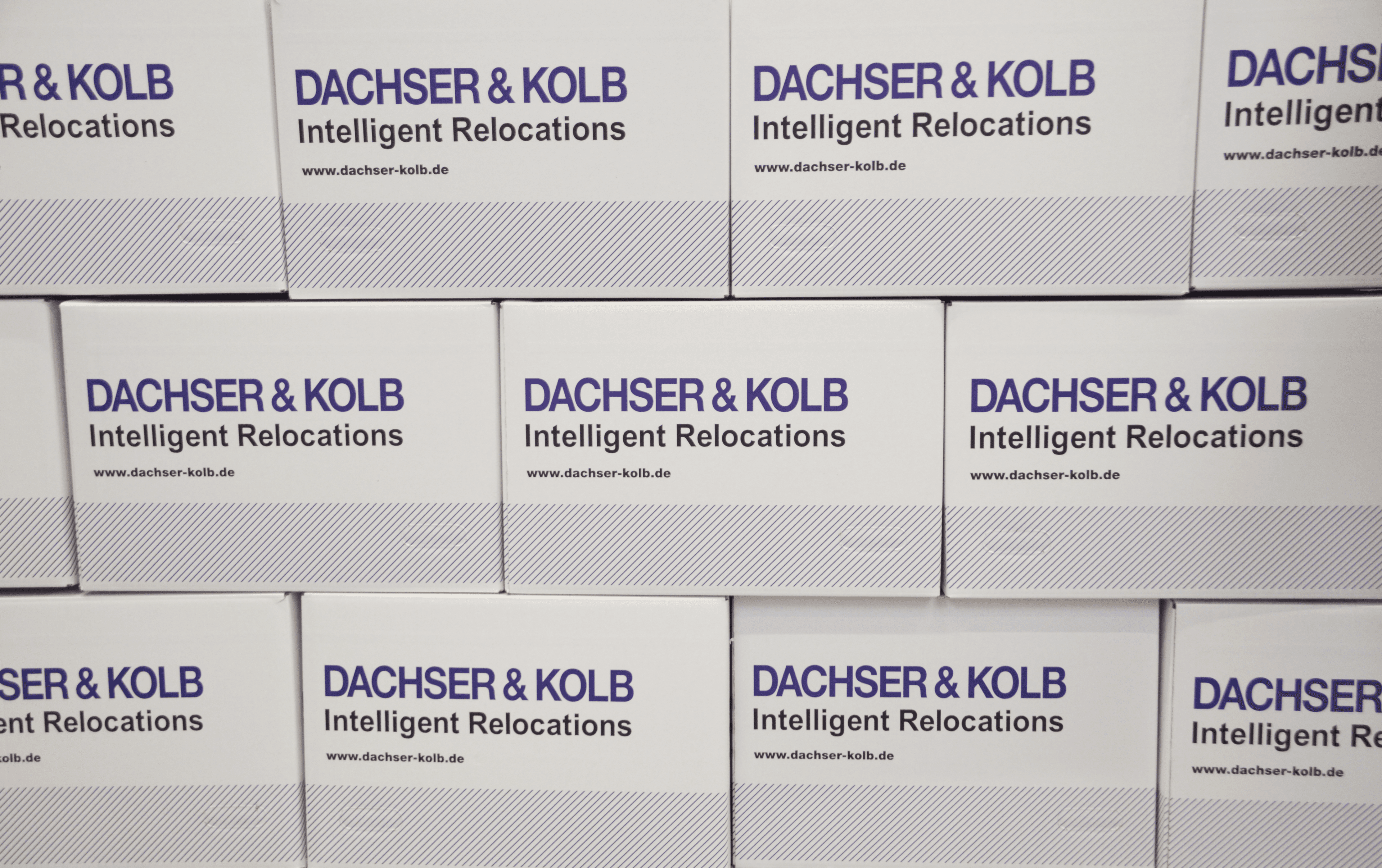Moving boxes by DACHSER & KOLB with slogan "Intelligent Relocations" – helpful moving tips from a relocation company.
