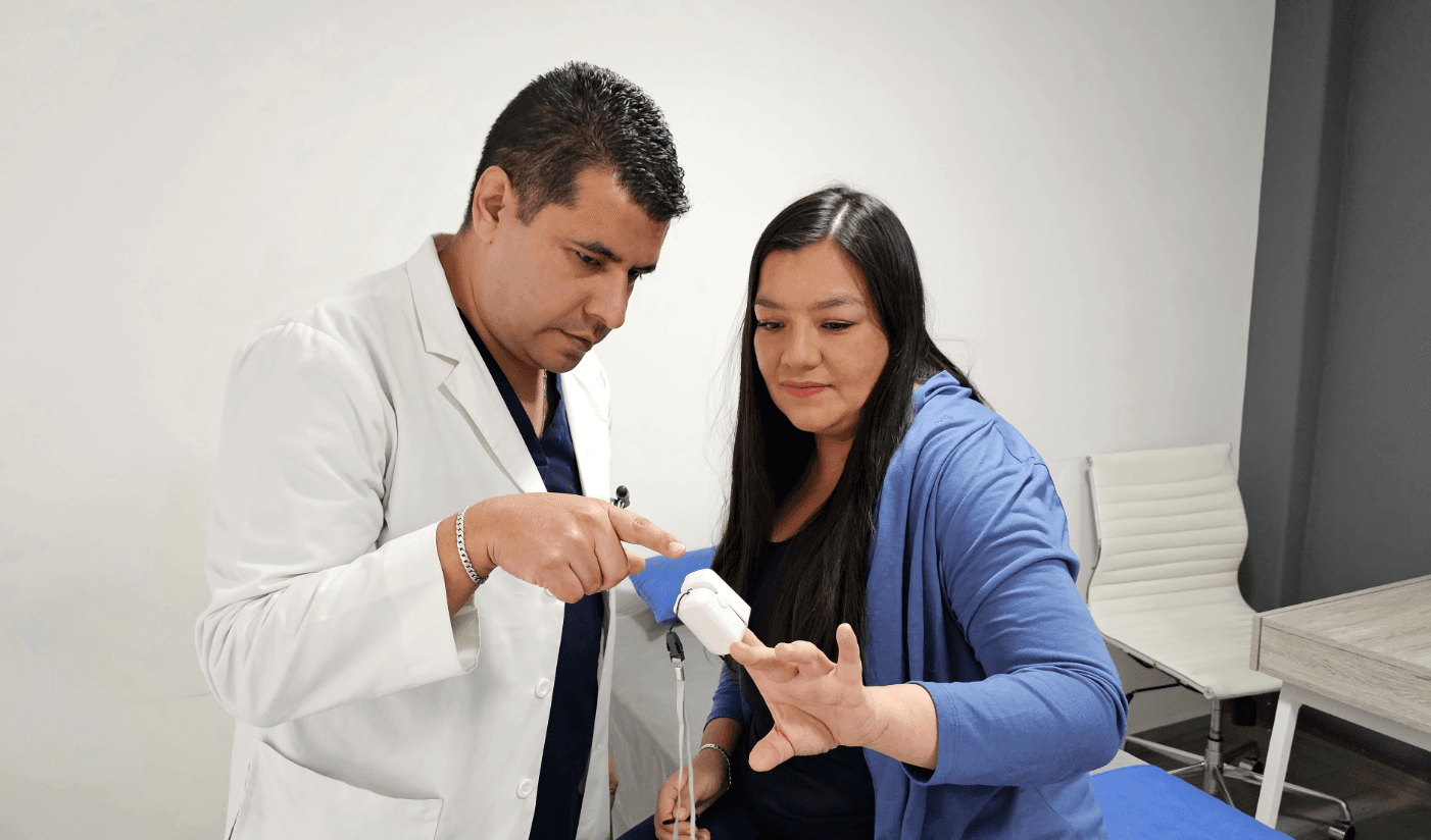 A doctor is using a pulse oximeter to measure a patient's vital signs