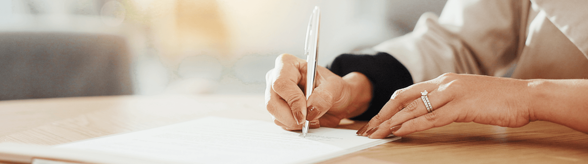 Close-up of a hand signing a high-value inventory list; focus on pen and official document.